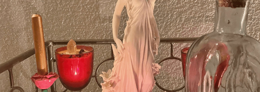 Altar with a statue of Aphrodite and several lit candles